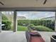 Charming patio features comfortable seating, a grill, and a view of the well-manicured backyard at 16150 Parkwyn St, Winter Garden, FL 34787