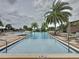 Resort style community pool featuring palm trees, lounge chairs and brick pavers at 16150 Parkwyn St, Winter Garden, FL 34787