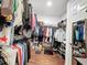 Large walk-in closet with wood floor, mirror, and abundant storage at 16150 Parkwyn St, Winter Garden, FL 34787