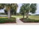 Walking path surrounded by lush landscaping, palm trees and a nearby lake at 16150 Parkwyn St, Winter Garden, FL 34787