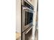 Modern kitchen featuring stainless steel double wall ovens, combining style and functionality for cooking at 16150 Parkwyn St, Winter Garden, FL 34787