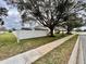 Residential street with a white fence enclosing a backyard and mature shade trees at 168 Bradwick Cir, Debary, FL 32713