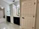 Beautifully appointed bathroom with a marble floor, stylish vanities, and elegant lighting fixtures at 168 Bradwick Cir, Debary, FL 32713