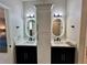 A modern bathroom with dual sinks, elegant white countertops, stylish lighting, and a central cabinet at 168 Bradwick Cir, Debary, FL 32713