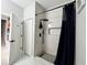 Contemporary bathroom showcasing a tiled shower with black fixtures and a decorative niche with modern tile flooring at 168 Bradwick Cir, Debary, FL 32713