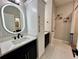 Modern bathroom with a white marble floor, sleek vanity, illuminated mirror, and a combined shower and bathtub at 168 Bradwick Cir, Debary, FL 32713