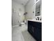 Bathroom featuring a modern vanity with dark blue cabinets, sleek fixtures, and decorative wall art at 168 Bradwick Cir, Debary, FL 32713