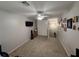 Open bonus room features neutral walls and carpet, ceiling fan, and a television ready for entertaining at 168 Bradwick Cir, Debary, FL 32713