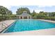 Large community pool for residents, surrounded by mature landscaping and comfortable seating areas at 168 Bradwick Cir, Debary, FL 32713