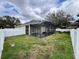 Enclosed patio with a grass area and white fence in the background at 168 Bradwick Cir, Debary, FL 32713