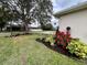 Landscaped front yard with flowerbeds, a lamppost, and a charger on the house at 168 Bradwick Cir, Debary, FL 32713