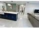 Modern kitchen features a central island with white countertop, navy blue cabinets, and elegant tile flooring at 168 Bradwick Cir, Debary, FL 32713