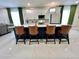 Gourmet kitchen island with quartz countertops, designer lighting, and bar seating at 168 Bradwick Cir, Debary, FL 32713