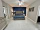 Stylish main bedroom features a tufted headboard, matching nightstands, and modern tile flooring at 168 Bradwick Cir, Debary, FL 32713