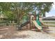 Community playground with slides and climbing structure shaded by a mature tree at 168 Bradwick Cir, Debary, FL 32713