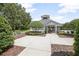 Community pool entrance with mature landscaping and an ornamental tree at 168 Bradwick Cir, Debary, FL 32713