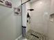 Shower featuring marble tile, mosaic floor, black showerhead, and toiletry storage at 168 Bradwick Cir, Debary, FL 32713
