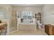 Bright bathroom features a garden tub, glass shower, and vanity area at 19331 Briercrest Trl, Orlando, FL 32833