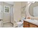 This clean bathroom features a shower, toilet, and vanity with sink, plus a decorative sign at 19331 Briercrest Trl, Orlando, FL 32833