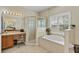 Bright bathroom features a garden tub, glass shower, and vanity area at 19331 Briercrest Trl, Orlando, FL 32833
