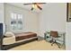 This cozy bedroom features a bed, a ceiling fan, natural light, and a desk at 19331 Briercrest Trl, Orlando, FL 32833