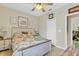 Comfortable bedroom features a ceiling fan, natural light, and a charming bed with floral bedding at 19331 Briercrest Trl, Orlando, FL 32833