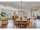 Elegant dining area with hardwood floors, chandelier, and views into the bright living room at 19331 Briercrest Trl, Orlando, FL 32833