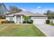 Charming single-story home with a well-manicured lawn, mature landscaping, and a two-car garage at 19331 Briercrest Trl, Orlando, FL 32833