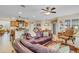 Open-concept living room featuring a kitchen island, dining area and comfortable seating at 19331 Briercrest Trl, Orlando, FL 32833