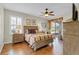 Serene main bedroom features hardwood floors, a ceiling fan, and a sliding glass door at 19331 Briercrest Trl, Orlando, FL 32833