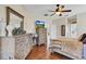 Bright main bedroom featuring hardwood floors, ceiling fan and en suite bathroom access at 19331 Briercrest Trl, Orlando, FL 32833