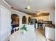 Bright kitchen featuring stainless steel appliances, with an adjacent dining area and arched doorway to living area at 222 Bent Oak Loop, Davenport, FL 33837