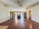 A large living room featuring gleaming hardwood floors, with arched doorways, and neutral-colored walls at 222 Bent Oak Loop, Davenport, FL 33837