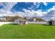 Lush backyard featuring a well-maintained lawn, white fence, storage shed, and a charming covered patio area at 2286 Sunny St, Kissimmee, FL 34741