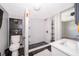 Bathroom features a tiled shower, tiled floors, and modern fixtures at 2286 Sunny St, Kissimmee, FL 34741