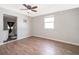 Bedroom features wood floors, window, and access to the bathroom at 2286 Sunny St, Kissimmee, FL 34741