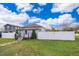 Charming home with a well-manicured lawn, stepping stone path, and a white picket fence at 2286 Sunny St, Kissimmee, FL 34741