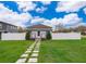 Charming home with a well-manicured lawn, stepping stone path, and a white picket fence at 2286 Sunny St, Kissimmee, FL 34741