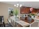 Dining room featuring a wooden table, light fixture and view of the open concept kitchen at 2711 Wadeview Loop, St Cloud, FL 34769