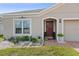 Charming home featuring a well-maintained lawn, decorative garden, and front entrance at 2711 Wadeview Loop, St Cloud, FL 34769