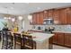 Open-concept kitchen featuring a central island with seating, pendant lights, and stainless steel appliances at 2711 Wadeview Loop, St Cloud, FL 34769