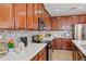 Well-lit kitchen featuring mosaic backsplash, white countertops, and modern appliances at 2711 Wadeview Loop, St Cloud, FL 34769