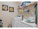 Functional laundry room equipped with modern appliances, shelving, and decorative touches at 2711 Wadeview Loop, St Cloud, FL 34769