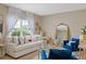Bright living room with a comfortable sofa, gold-accented tables, and stylish décor at 2711 Wadeview Loop, St Cloud, FL 34769