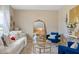 Inviting living room with a plush sofa, elegant mirror, and chic decorative accents at 2711 Wadeview Loop, St Cloud, FL 34769