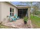 Outdoor patio with stylish furniture, plants, and a view of the backyard at 2711 Wadeview Loop, St Cloud, FL 34769