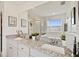 Bathroom with double sinks, granite countertops, and a glass-enclosed shower at 2800 Cello Ln, Kissimmee, FL 34741
