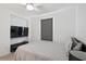 Comfortable bedroom featuring a ceiling fan, neutral decor, and a mounted TV at 2800 Cello Ln, Kissimmee, FL 34741