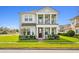Charming two-story home featuring a welcoming porch and manicured front lawn at 2800 Cello Ln, Kissimmee, FL 34741