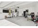 Spacious garage with a clean epoxy floor, ample storage, and a wall mounted television at 2800 Cello Ln, Kissimmee, FL 34741